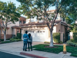 Home Purchase image of couple looking at their dream home - The Parent Team mortgage loan office
